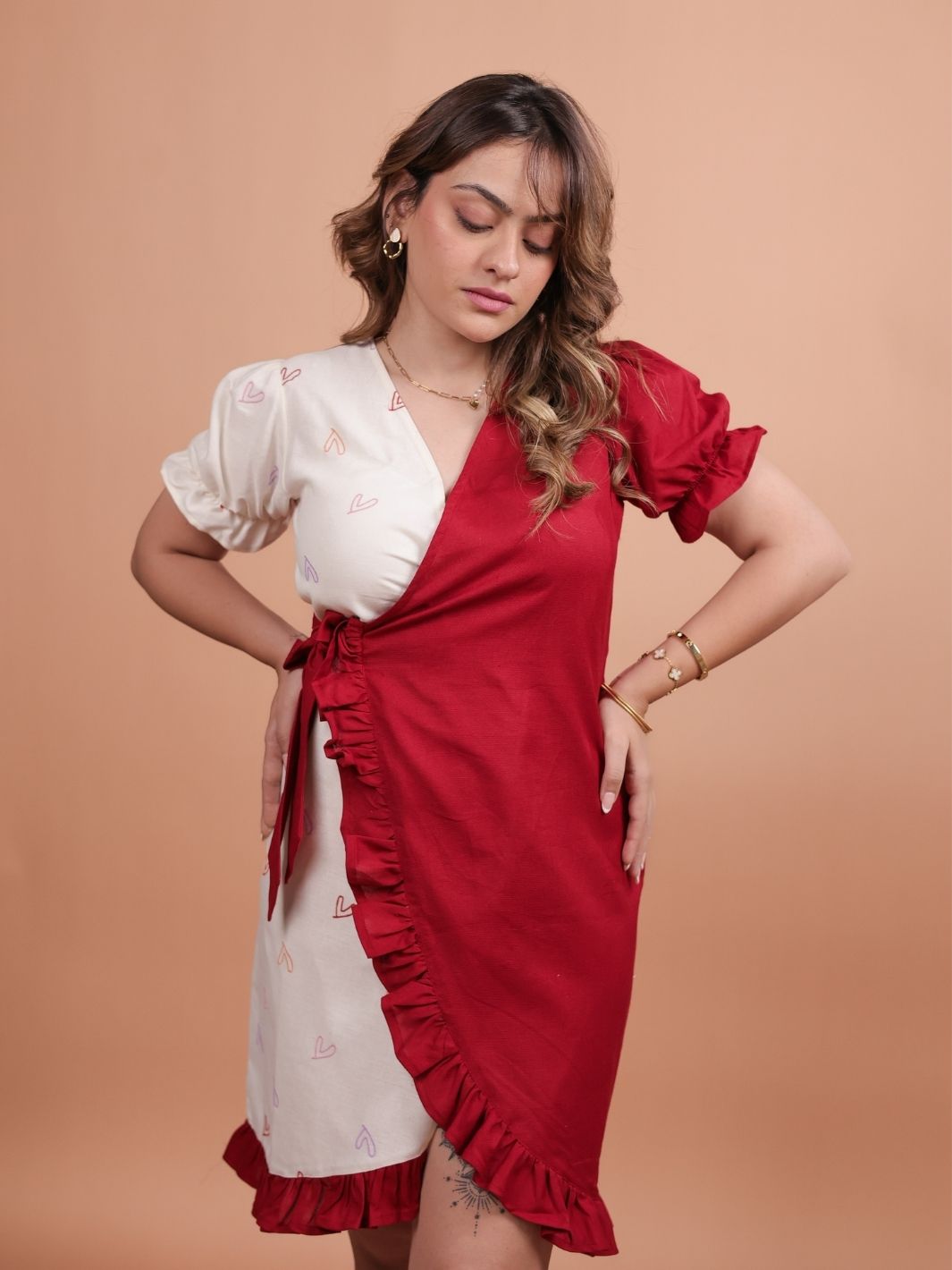 Hearts Red Ruffle Wrap Dress featuring a playful heart print, flattering ruffle design, and adjustable wrap closure.