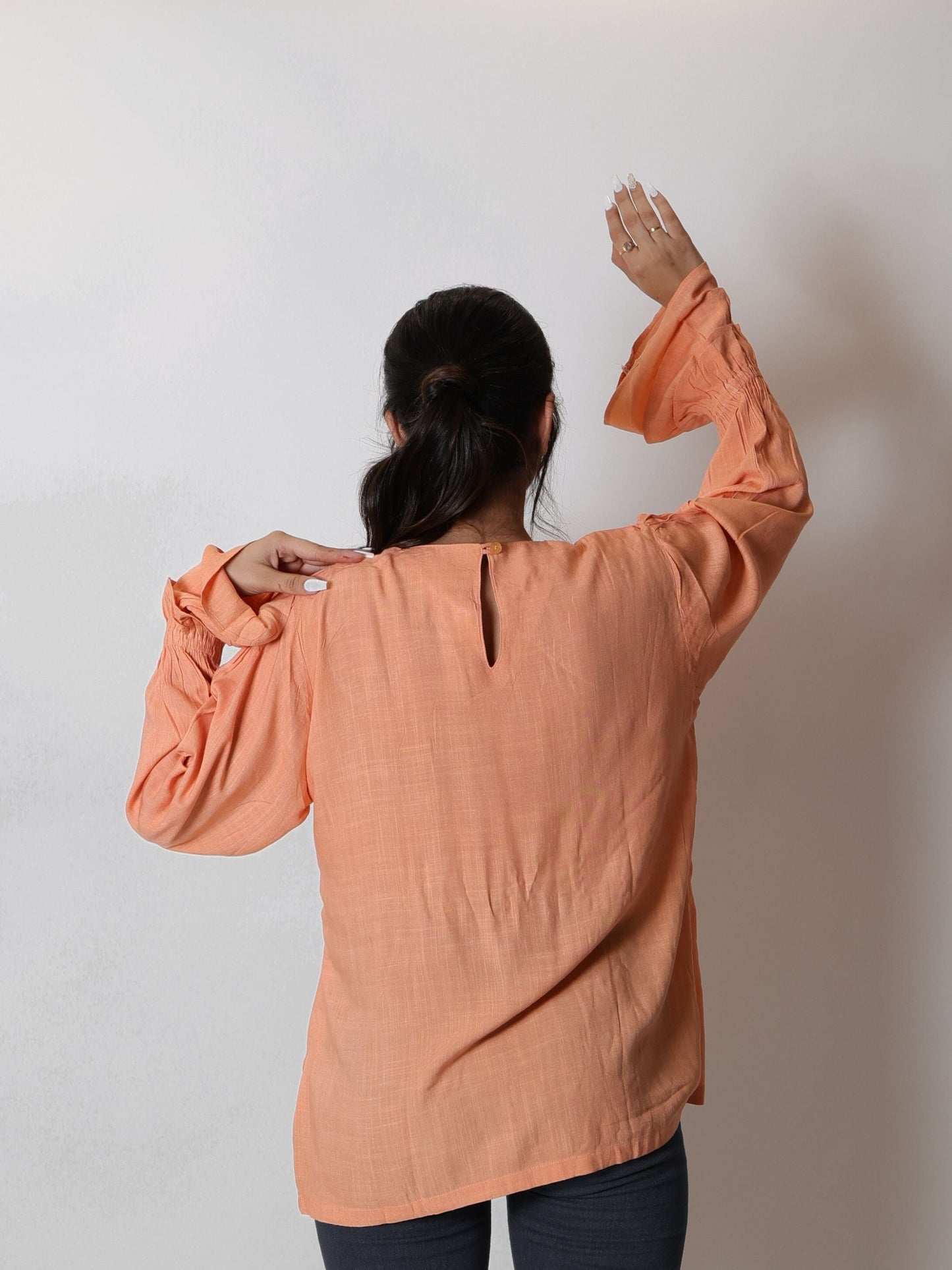 Coral Peach Long Blouse Top featuring a flowy design and vibrant coral peach color, ideal for layering or wearing alone. Perfect for both casual outings and formal events, this blouse combines elegance with comfort.