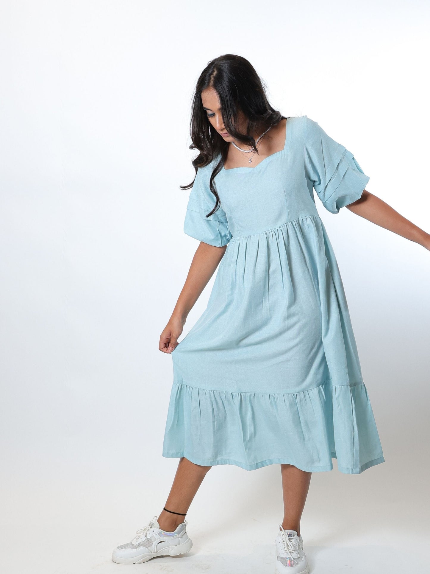 Our Aqua Blue tiered dress is a midi length, fully lined dress with puff sleeves, sweetheart neckline and a delicate tiered hem.