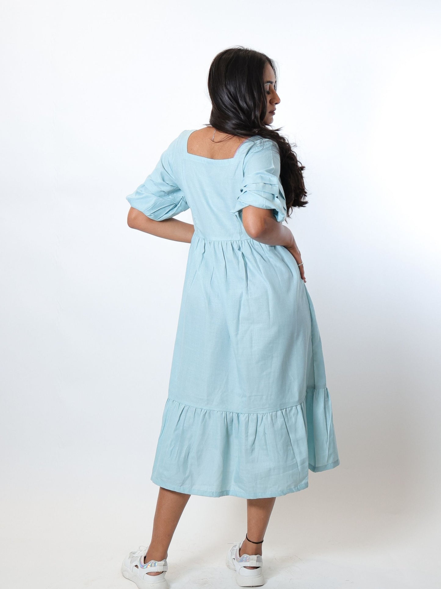 Our Aqua Blue tiered dress is a midi length, fully lined dress with puff sleeves, sweetheart neckline and a delicate tiered hem.