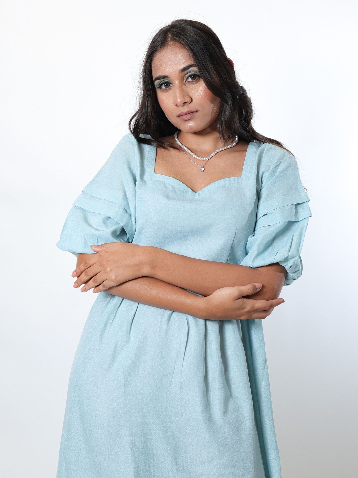 Our Aqua Blue tiered dress is a midi length, fully lined dress with puff sleeves, sweetheart neckline and a delicate tiered hem.